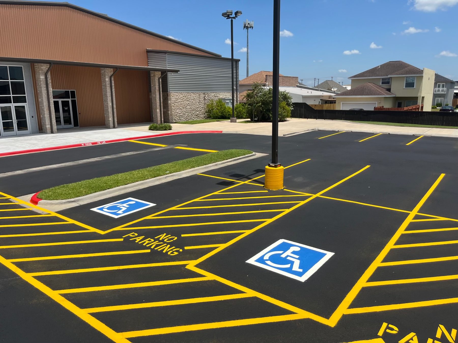 Fresh yellow striping and accessible parking at a commercial building